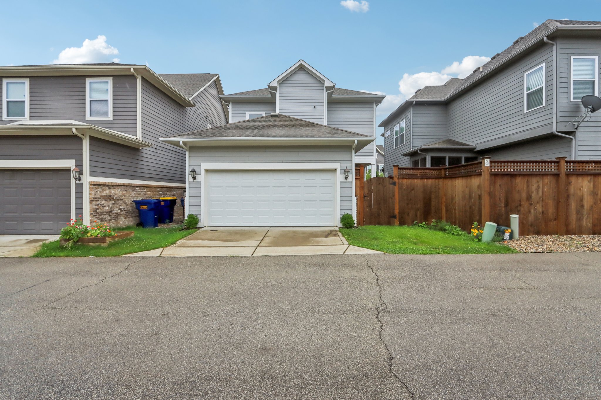 Two-car garage with alley access and fenced-in yard—function meets security.