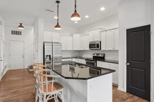 Spacious and stylish kitchen with oversized island, ample prep space, and bar seating for gatherings.