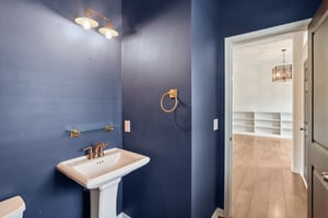 Stylish main-level half bath with modern fixtures—perfect for guests and everyday convenience.
