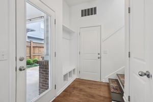 Thoughtfully designed rear entry with built-in cubbies and coat rack—practical storage meets polished style.