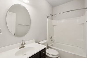 Fresh and functional guest bath with a clean modern vanity and shower/tub combo.