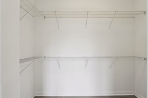 Expansive walk-in closet in the primary suite with built-in shelving and generous hanging space.