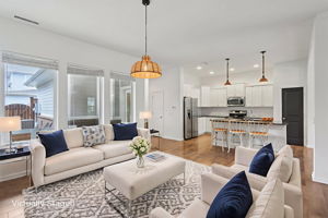 Open and airy family room with backyard views, seamless kitchen flow, and space to live large in style. virtually staged watermark