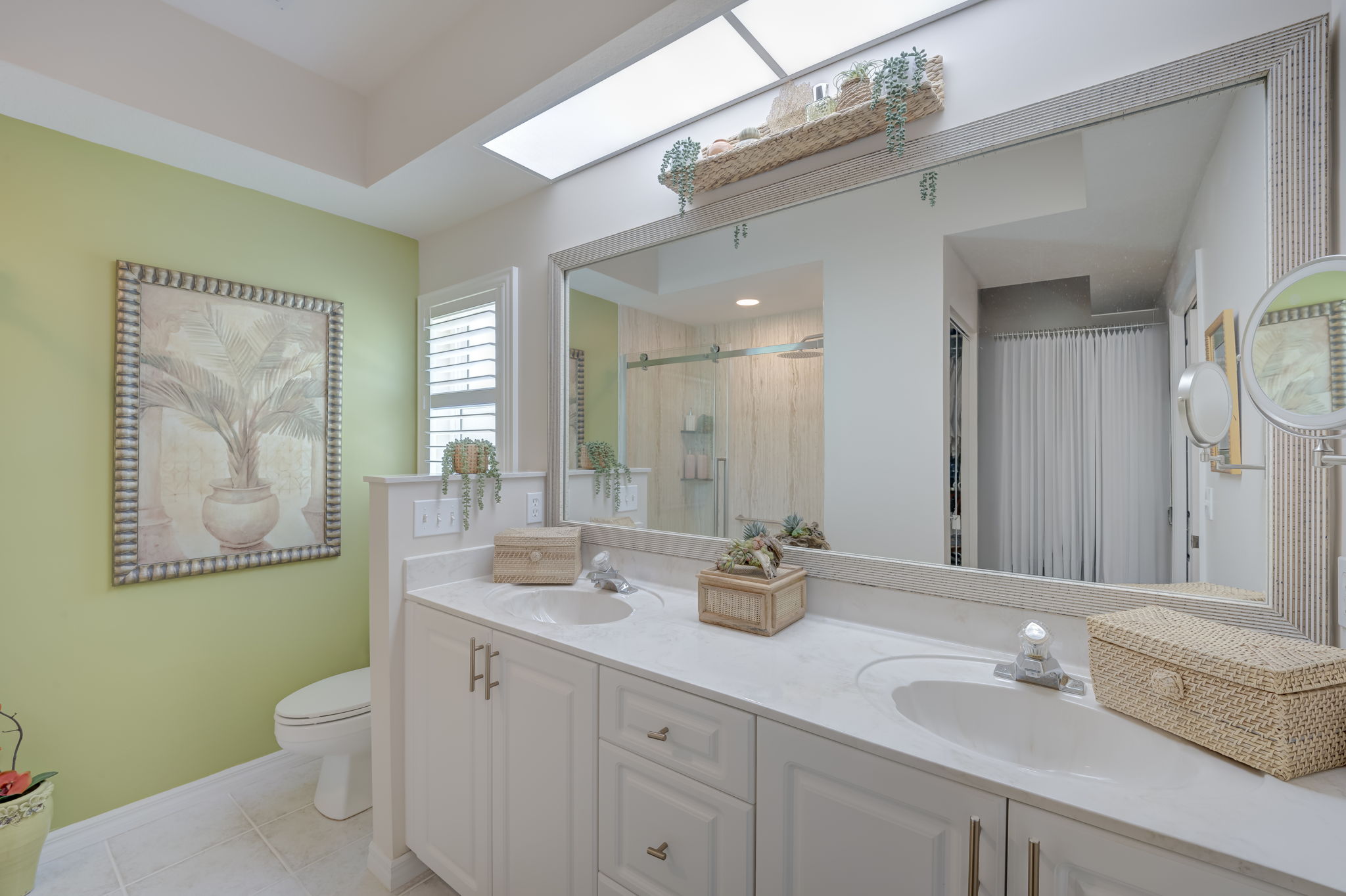 Spa-inspired en-suite primary bathroom featuring an extended dual-sink vanity