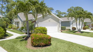 Tropical paradise - entry into the home has palms, evening lighting, and massive curb appeal