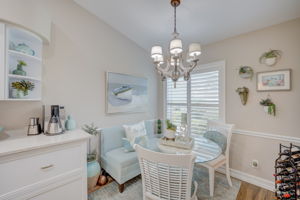 Bright eat-in kitchen with extended countrtops, nook featuring large energy-efficient windows with plantation shutters,luxury tile floors, and space for casual dining
