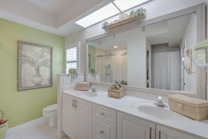 Spa-inspired en-suite primary bathroom featuring an extended dual-sink vanity