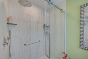 Upgraded primary bathroom featuring a luxurious NEW walk-in shower