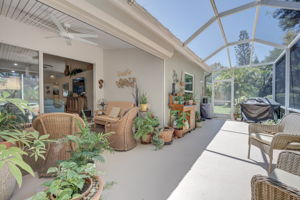 Fully screened-in outdoor lanai space featuring durable concrete decking, perfect for bug-free alfresco dining and entertaining