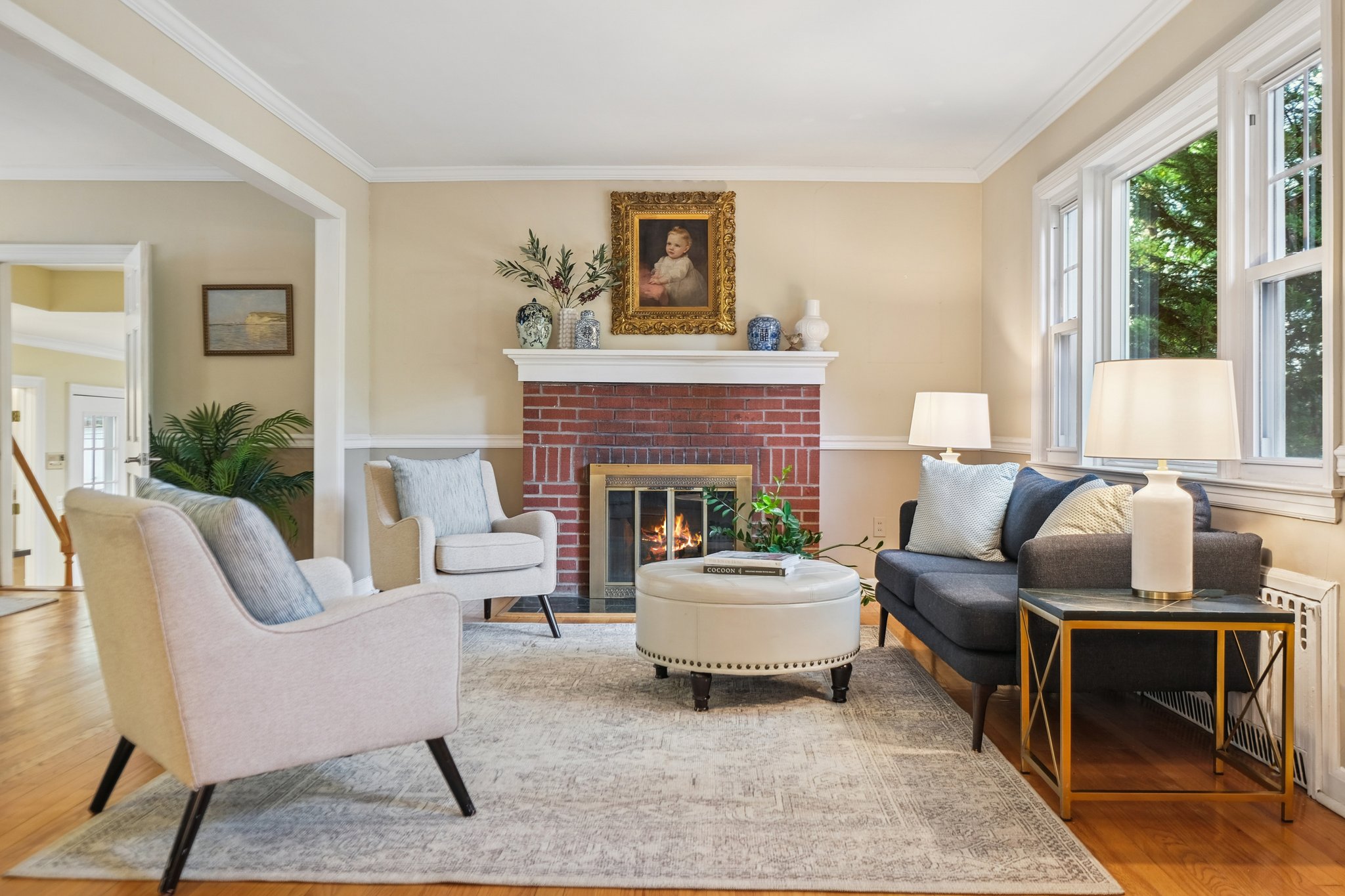 A living room made for golden afternoons and candlelit nights - where wide mid-century windows flood the space with sunshine by day and twinkle with warmth after dark.
