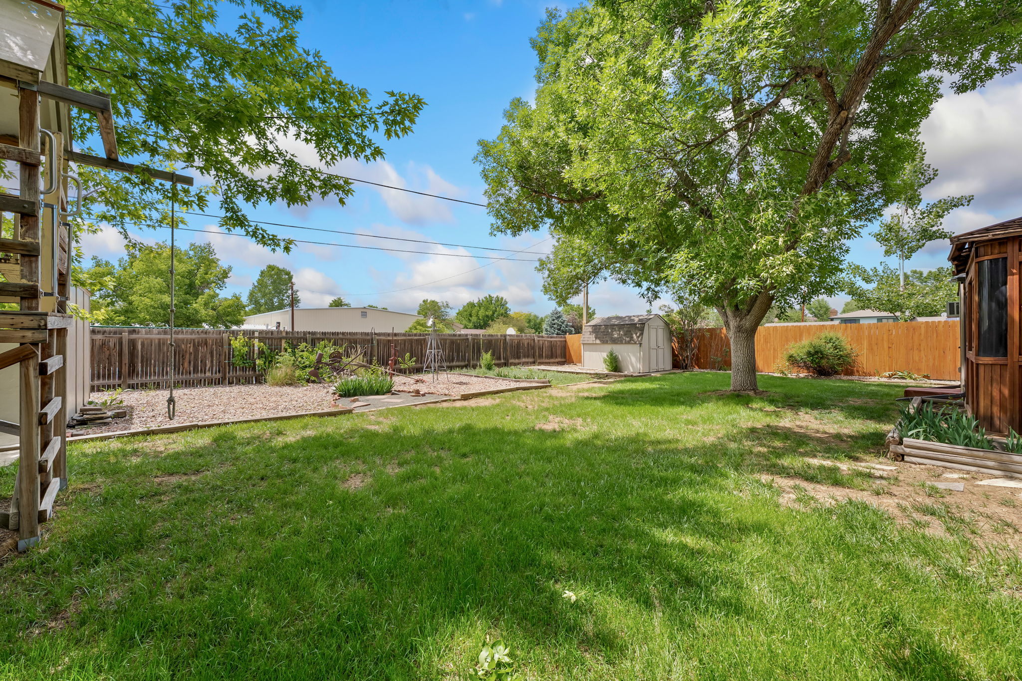 View to the back of the 1/4 acre property with large garden area and 2 sheds.
