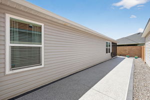 Side Patio with Low-Maintenance Stoned Landscaping