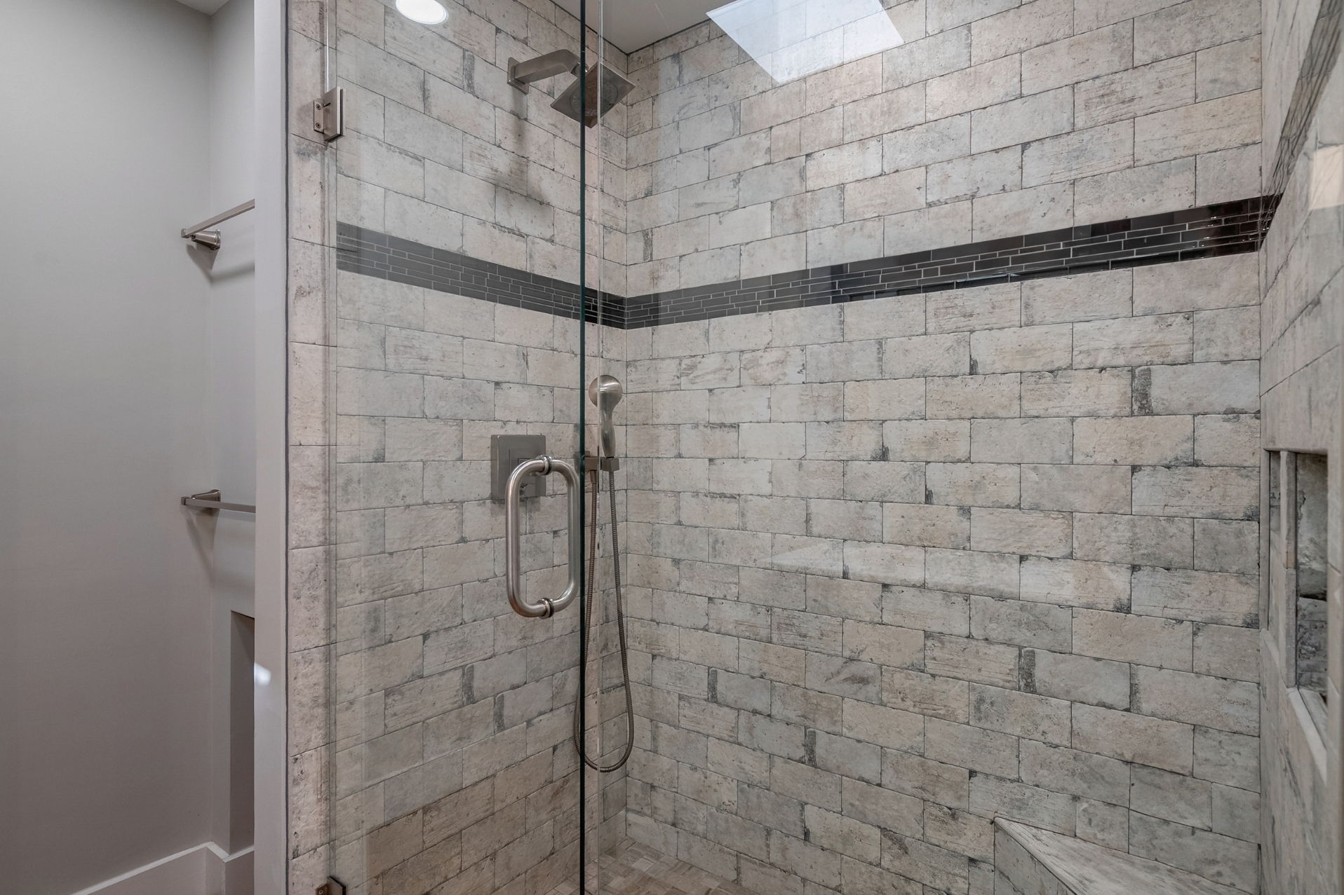 Stone shower with frames shower door and wall