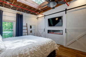 Electric fireplace & barn doors cover 2 additional closets