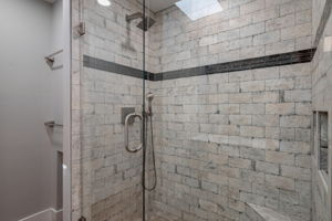 Stone shower with frames shower door and wall