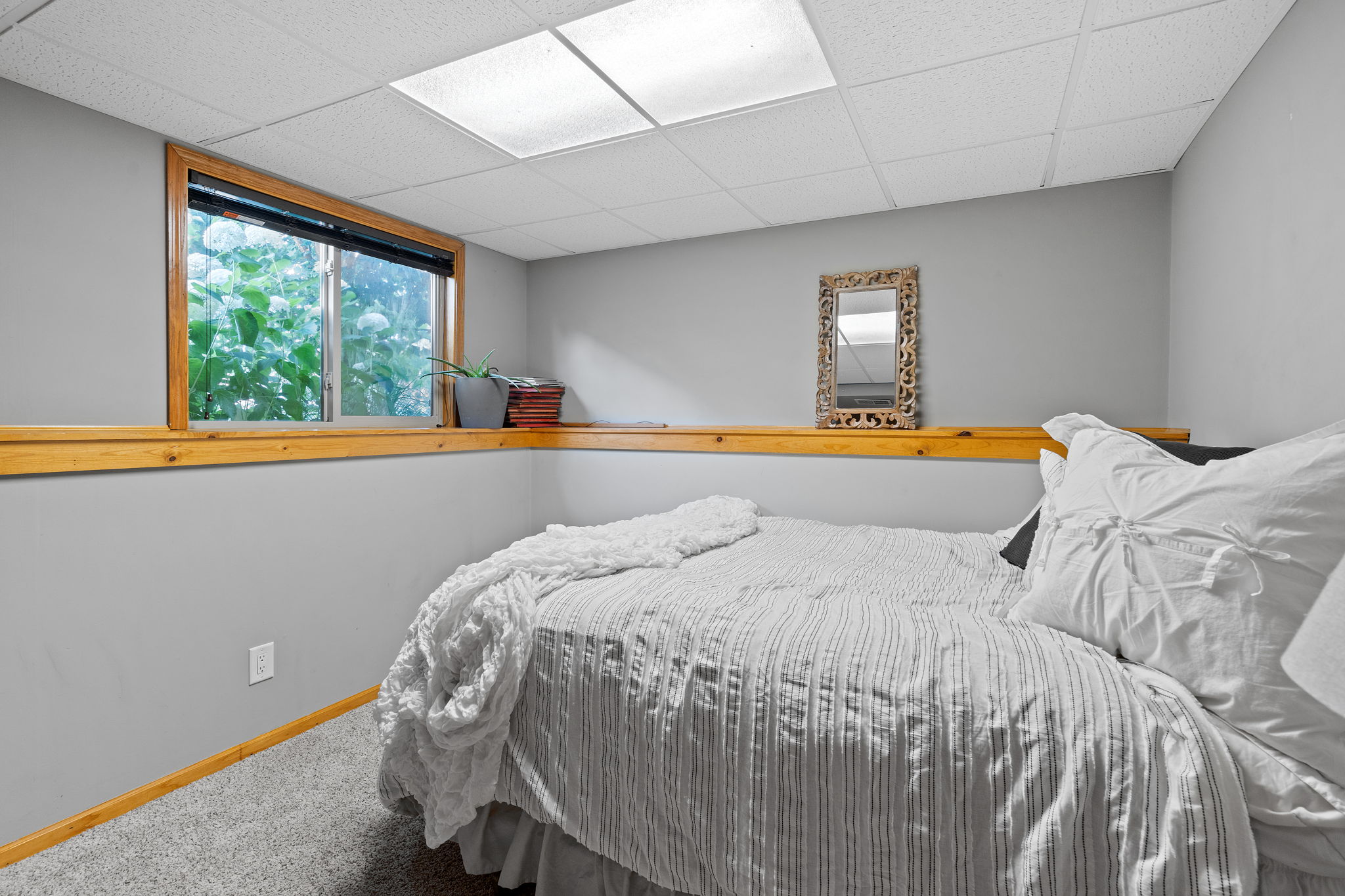 The smaller lower-level bedroom at 5857 Oneka Lake Boulevard N is perfect as a tucked-away bedroom retreat, but could also make an ideal home office.