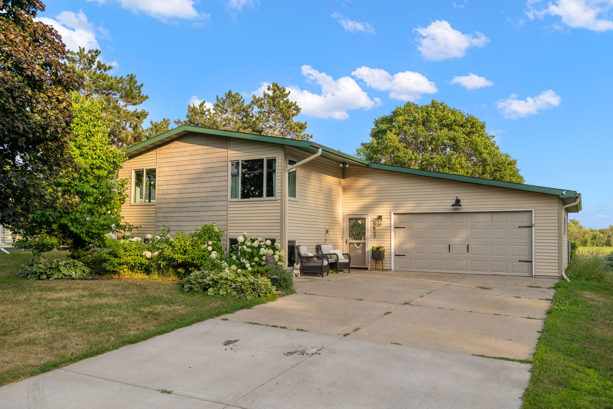 5857 Oneka Lake Boulevard N welcomes you with plenty of concrete driveway capacity, coupled with an oversized 2-car attached garage.