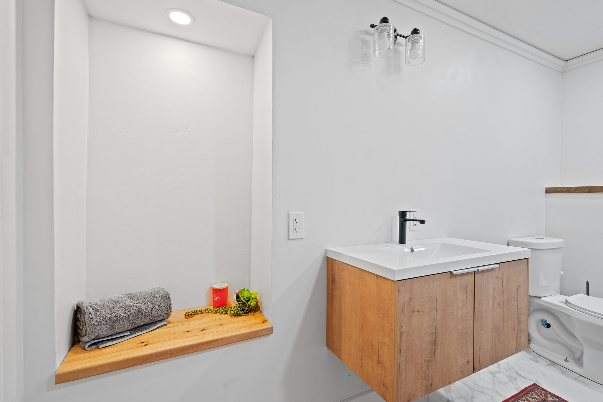 The lower level at 5857 Oneka Lake Boulevard N features this newly renovated full bathroom, complete with a large soaker tub and a separate shower stall with a ceiling-mounted rain shower head.