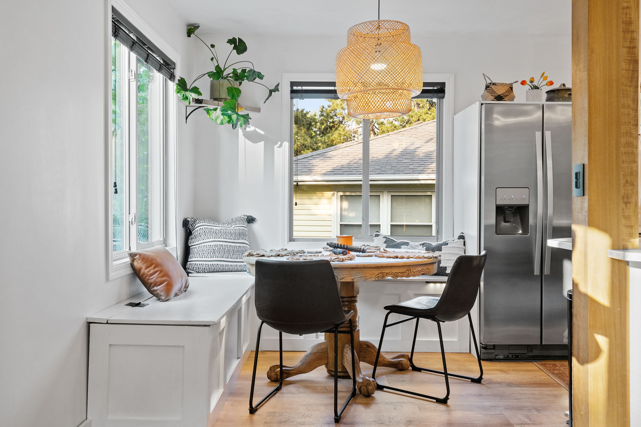 Adjacent to the bright, new kitchen at 5857 Oneka Lake Boulevard N is the eat-in dining space with built-in benches and nice large windows.