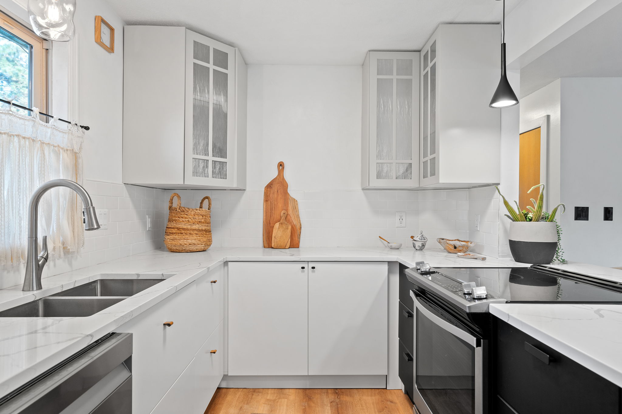 The centerpiece of the renovated upper level at 5857 Oneka Lake Boulevard N is the beautifully updated kitchen, featuring quartz countertops and stainless steel appliances.