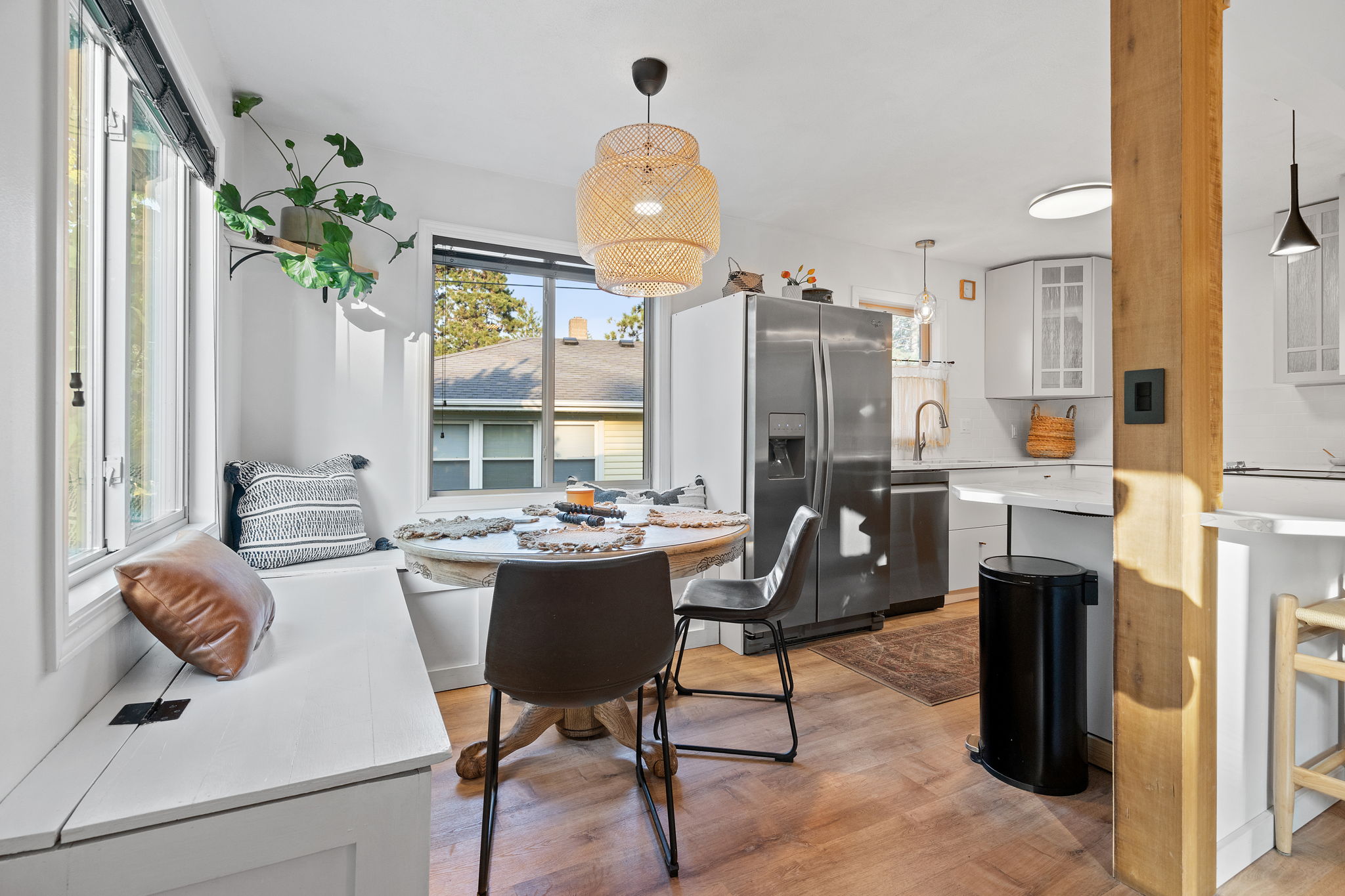 Adjacent to the bright, new kitchen at 5857 Oneka Lake Boulevard N is the eat-in dining space with built-in benches and nice large windows.