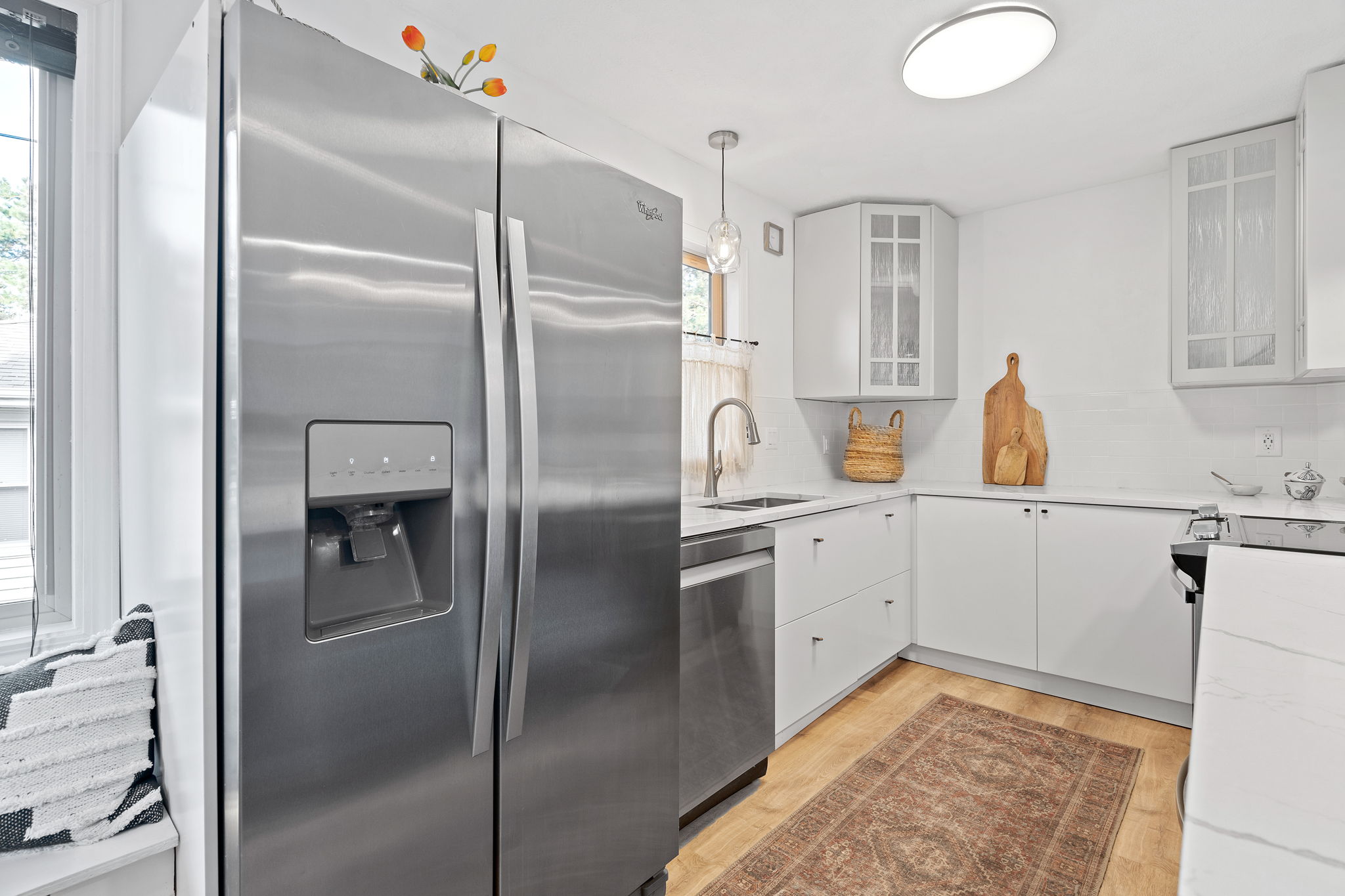 The centerpiece of the renovated upper level at 5857 Oneka Lake Boulevard N is the beautifully updated kitchen, featuring quartz countertops and stainless steel appliances.