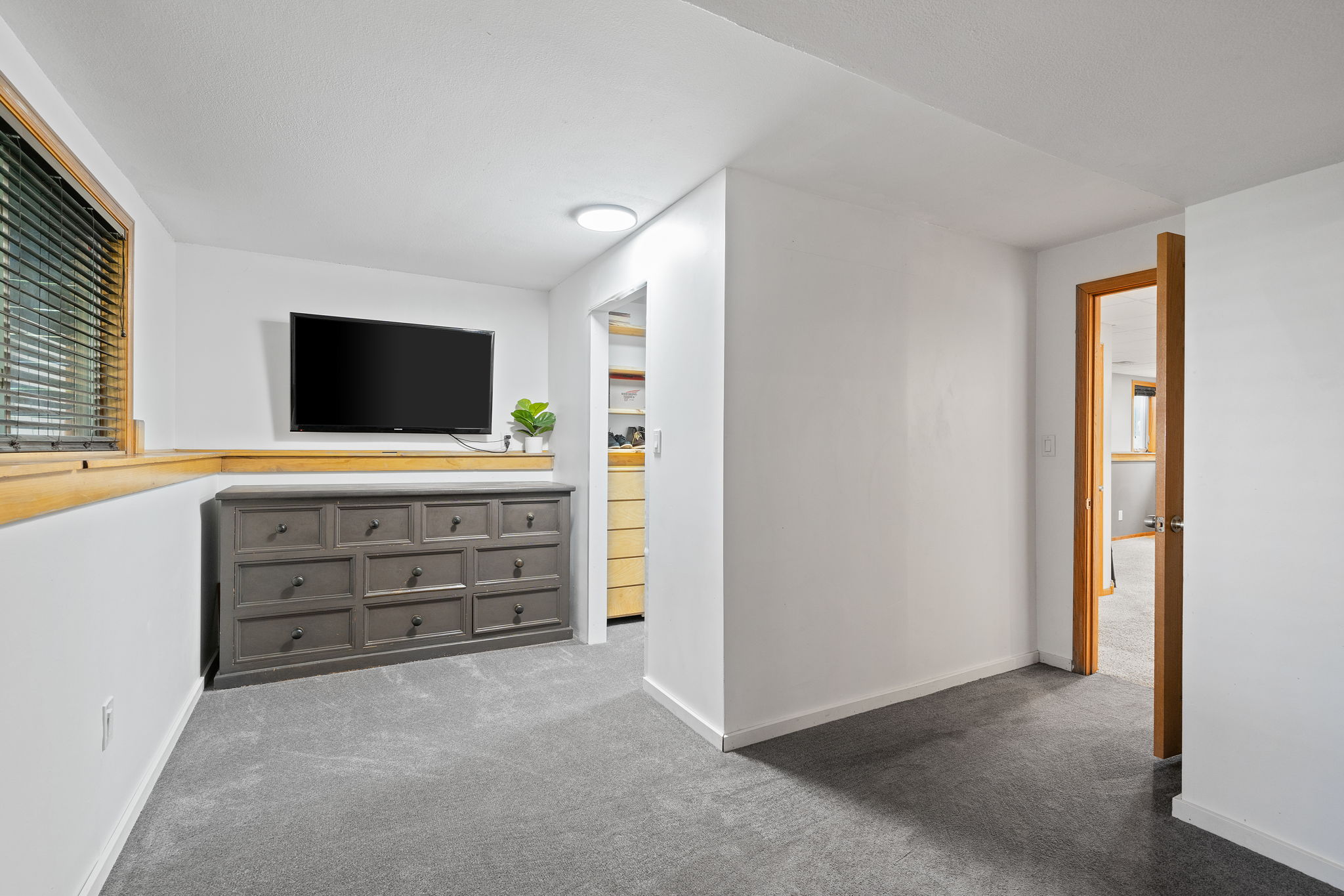 The expansive lower-level primary bedroom at 5857 Oneka Lake Boulevard N features a walk-in closet.