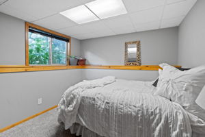 The smaller lower-level bedroom at 5857 Oneka Lake Boulevard N is perfect as a tucked-away bedroom retreat, but could also make an ideal home office.