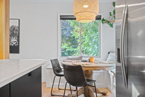 Adjacent to the bright, new kitchen at 5857 Oneka Lake Boulevard N is the eat-in dining space with built-in benches and nice large windows.