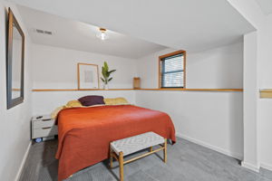 The expansive lower-level primary bedroom at 5857 Oneka Lake Boulevard N features a walk-in closet.