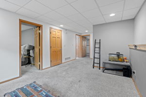 The finished basement at 5857 Oneka Lake Boulevard N begins with a spacious, wide family room without sacrificing on natural light.