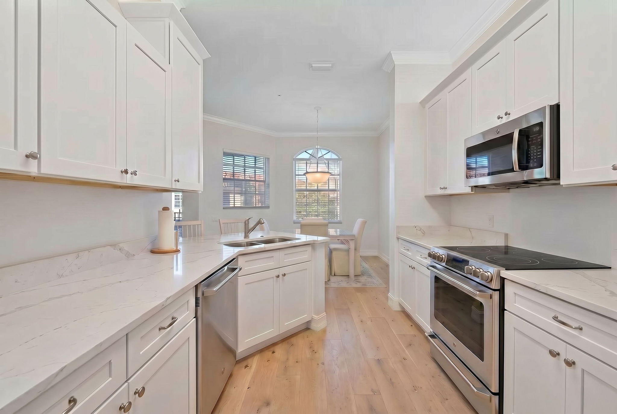 Digitally Enhanced  white cabinets, white walls and SS appliances.