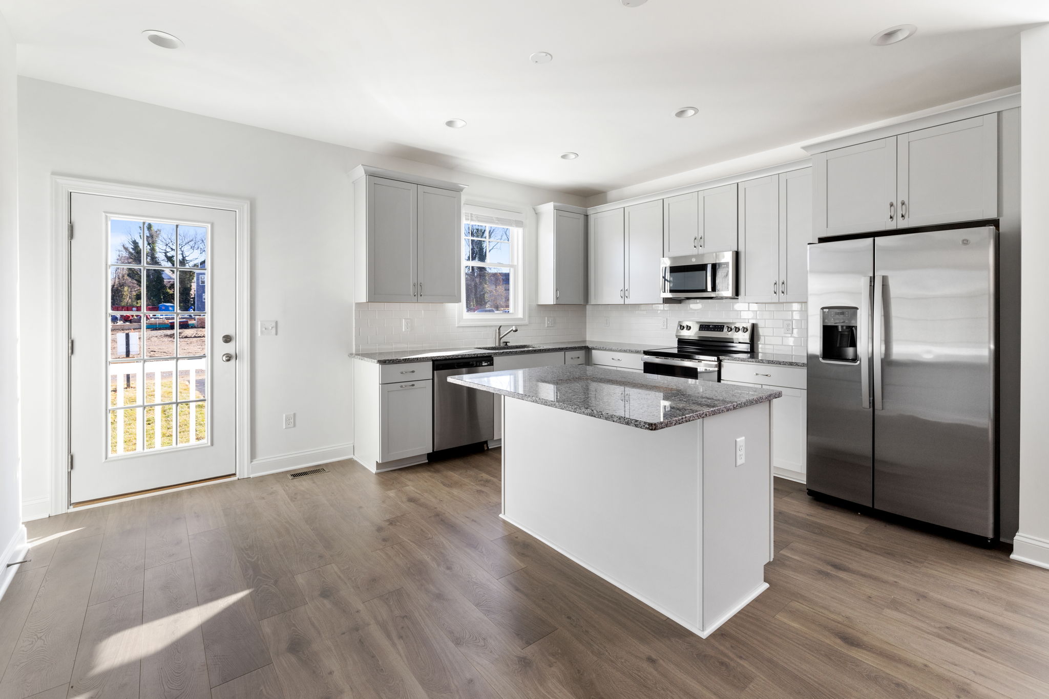 Rear entrance to kitchen.  LVP flooring throughout.