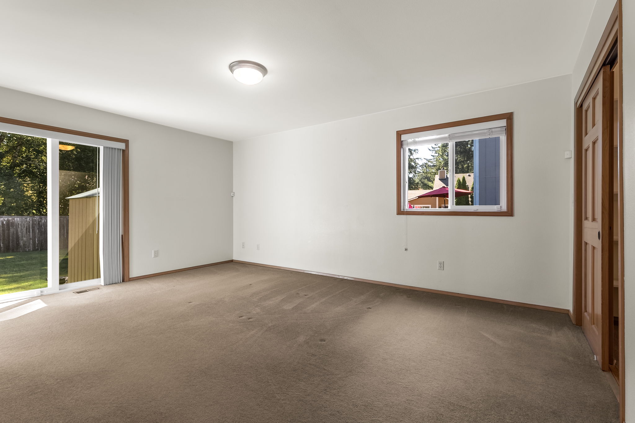 Large walk in closet is hidden behind those closet doors.