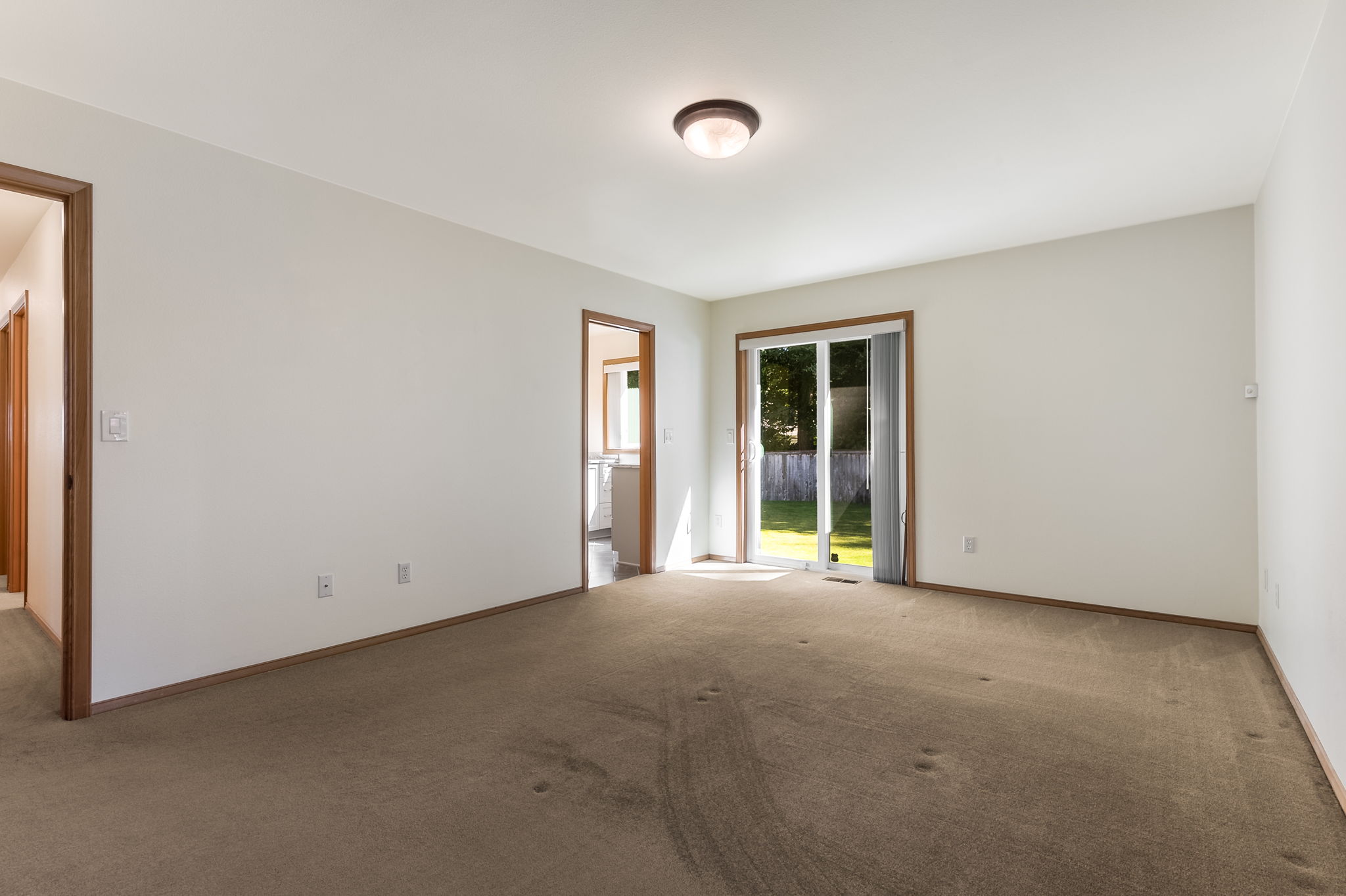 Primary suite with it's own slider door to the back yard.