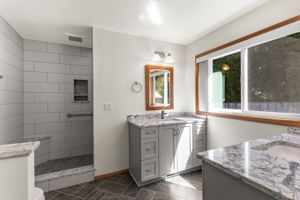 Updated primary bath with two separate Quartz undermount sinks.