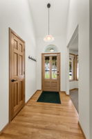 Vaulted hardwood entry is full of natural light. All of the interior doors in the home are solid core Hemlock.