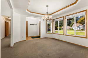 Formal dining room with wood trimmed trayed ceiling and large windows. All windows were replaced just 5 years ago!