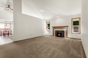 Enter into the living room that features a cozy gas fireplace.