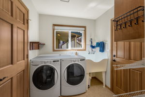 Large mudroom features the coolest utility sink/dog washing station!