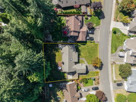 Mature green belt area behind the property provides shade and privacy.