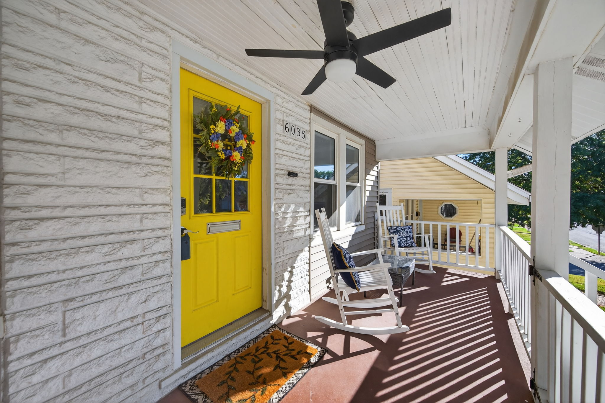 Isn't this covered front porch inviting?  Bonus- it is fully gated so your pup or kiddos can safely join you.  Write the porch swing and rockers into the contract!