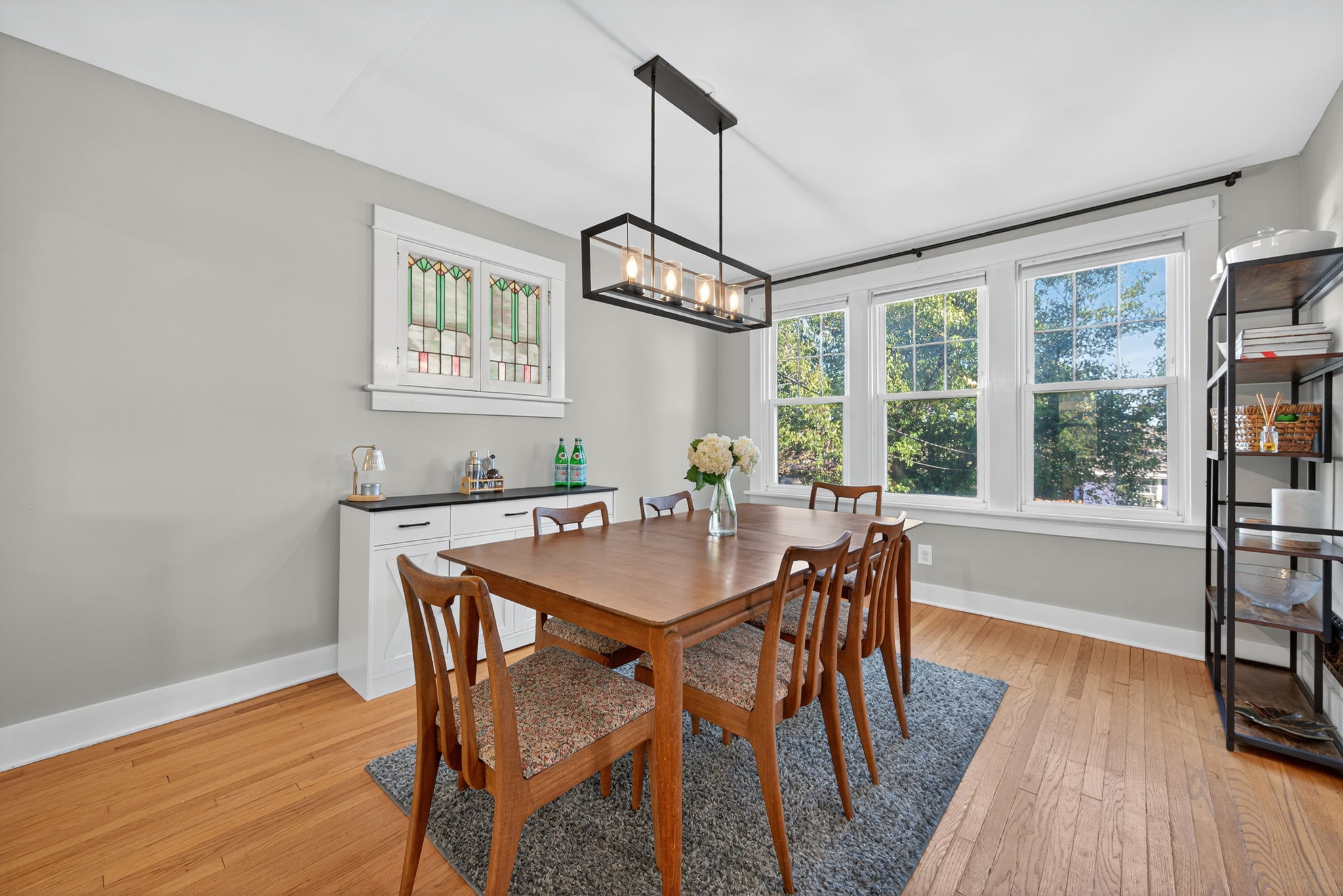 The formal dining room is an impressive size with a lovely tbackyard view and warm light from the century old stained glass windows.