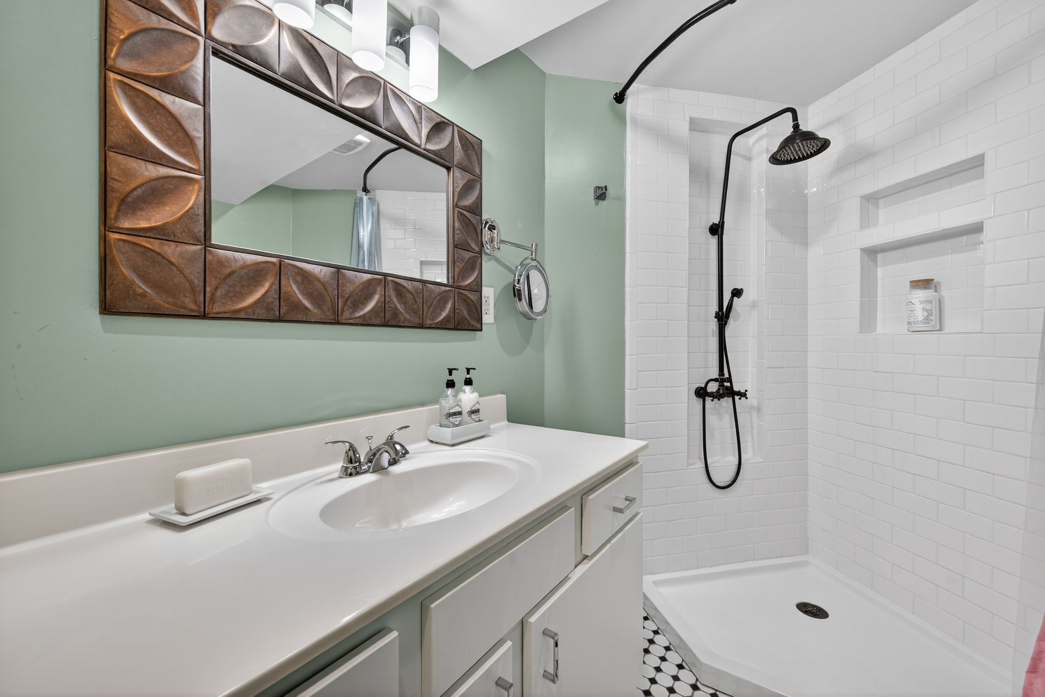 The lower level bathroom has a gorgeous shower surround and oversized vanity.