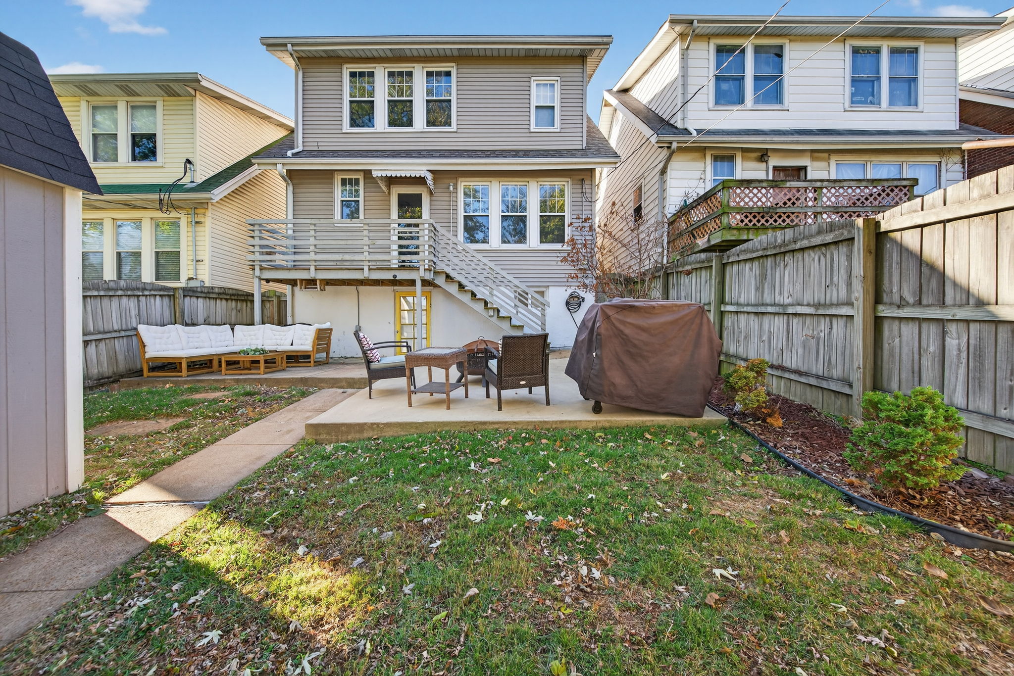 Heading outside, the adorable backyard is fully-fenced with a small deck, newer concrete patios, a newer shed for storage, and garden beds already installed.