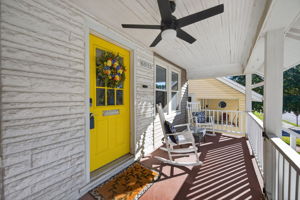 Isn't this covered front porch inviting?  Bonus- it is fully gated so your pup or kiddos can safely join you.  Write the porch swing and rockers into the contract!
