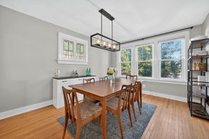 The formal dining room is an impressive size with a lovely tbackyard view and warm light from the century old stained glass windows.