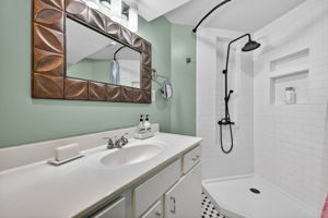The lower level bathroom has a gorgeous shower surround and oversized vanity.