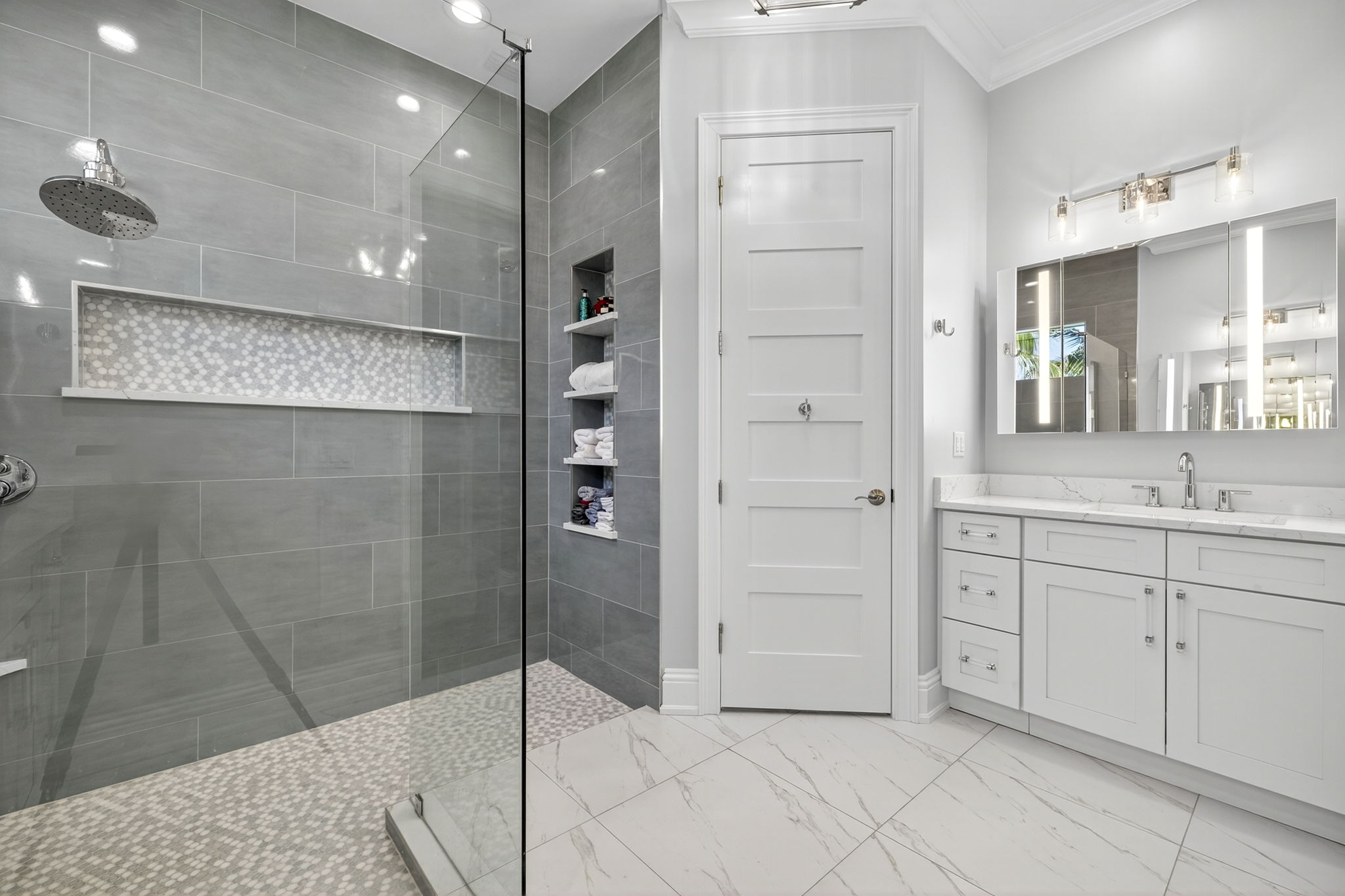 Primary Bathroom with 2nd vanity, lighted storage mirror & custom frameless shower & built in niches