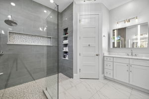Primary Bathroom with 2nd vanity, lighted storage mirror & custom frameless shower & built in niches